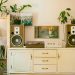 Retro home interior featuring vintage stereo, speakers, and houseplants for cozy atmosphere.