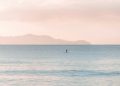 person paddle boarding during daytime