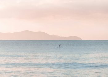 person paddle boarding during daytime