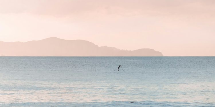 person paddle boarding during daytime
