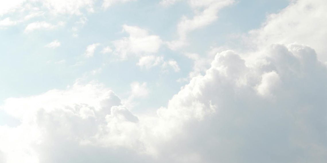 A serene view of thick, fluffy clouds set against a bright blue sky, perfect for backgrounds.