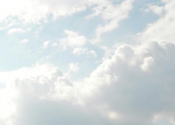 A serene view of thick, fluffy clouds set against a bright blue sky, perfect for backgrounds.