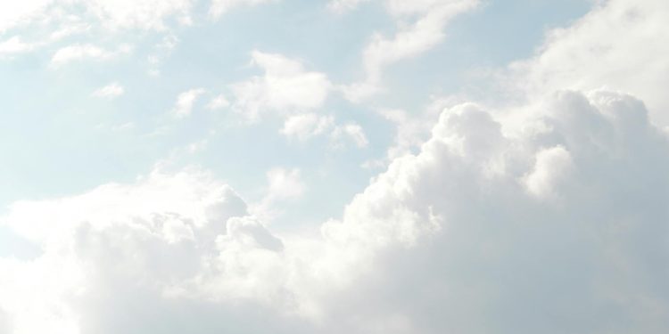 A serene view of thick, fluffy clouds set against a bright blue sky, perfect for backgrounds.