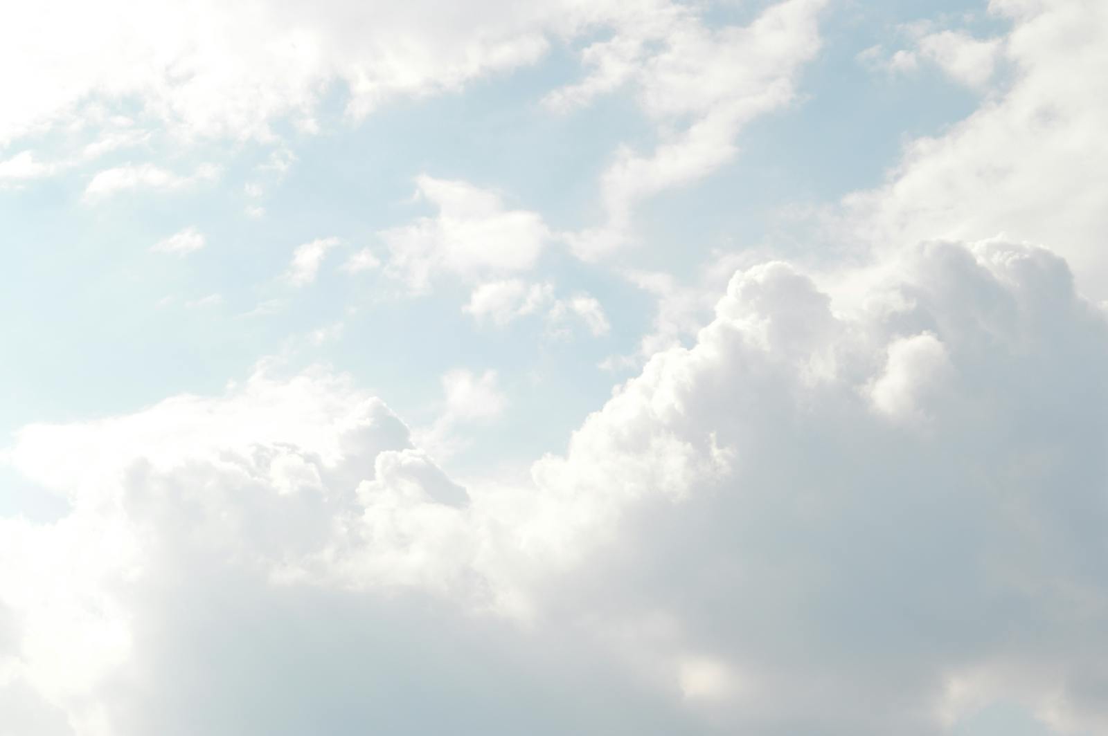 A serene view of thick, fluffy clouds set against a bright blue sky, perfect for backgrounds.