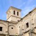 Stone monastery in Andalusian city with clear blue sky and classic architecture.