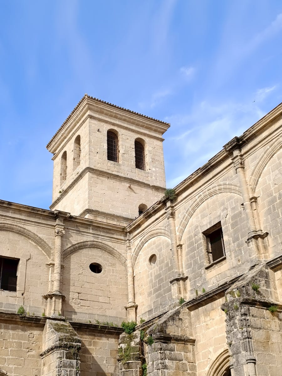 Stone monastery in Andalusian city with clear blue sky and classic architecture.
