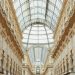 Beautiful view of Galleria Vittorio Emanuele II's interior glass roof and intricate facade in Milan, Italy.