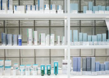 A clean and organized display of skincare products on shelves, perfect for beauty enthusiasts.