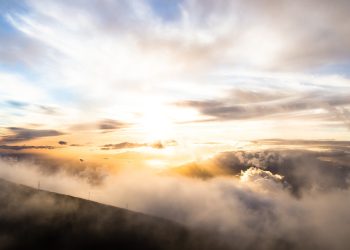 clouds above mountains during golden hour