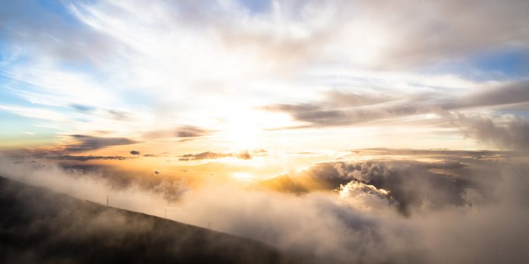 clouds above mountains during golden hour